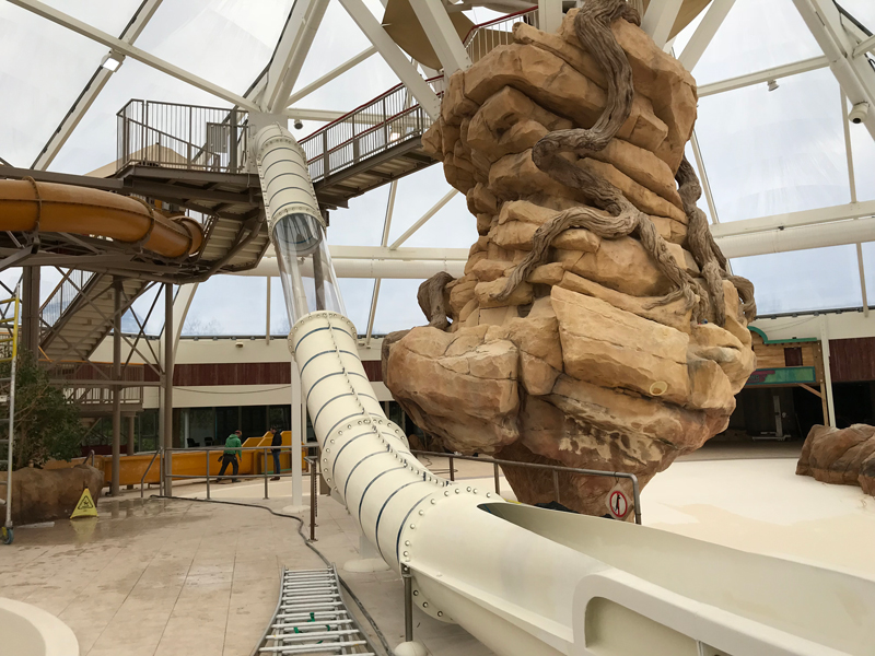 Indoor water attraction with a tube slide in a swimming paradise, during maintenance
